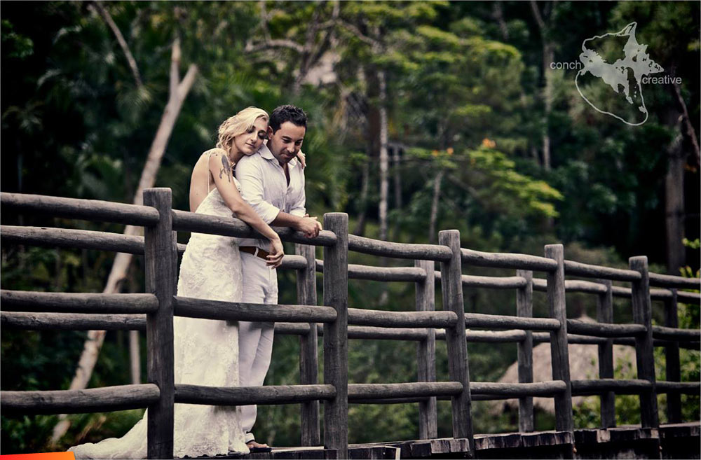 Newlyweds on a bridge at Blancaneaux Lodge
