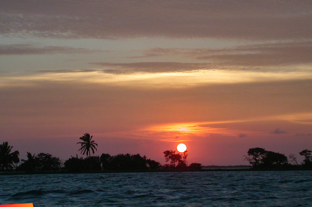 Sunset over Blackbird Caye Resort