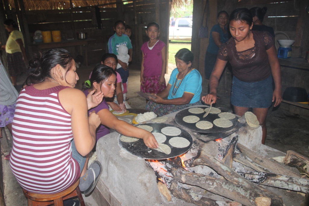 The tortillas are are cooked on  top of the iron "comal" above the fire fed with wood