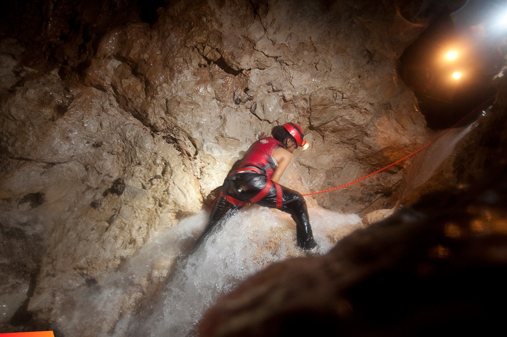 Climbing over a waterfall in the caves