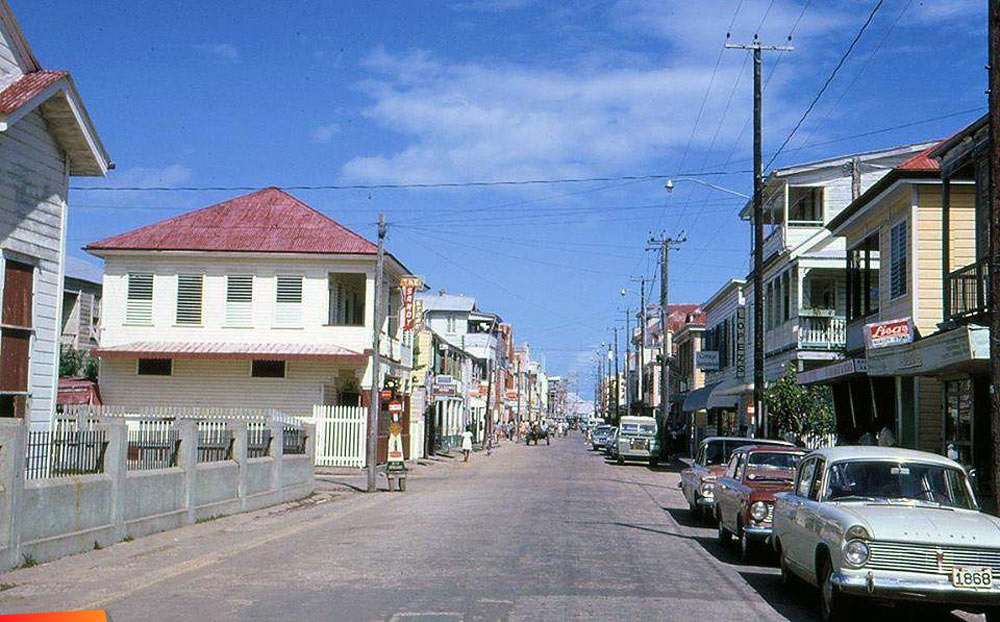 Albert Street showing Lopez Drug Store and a newly painted Channel 7 building, in Belize City long ago