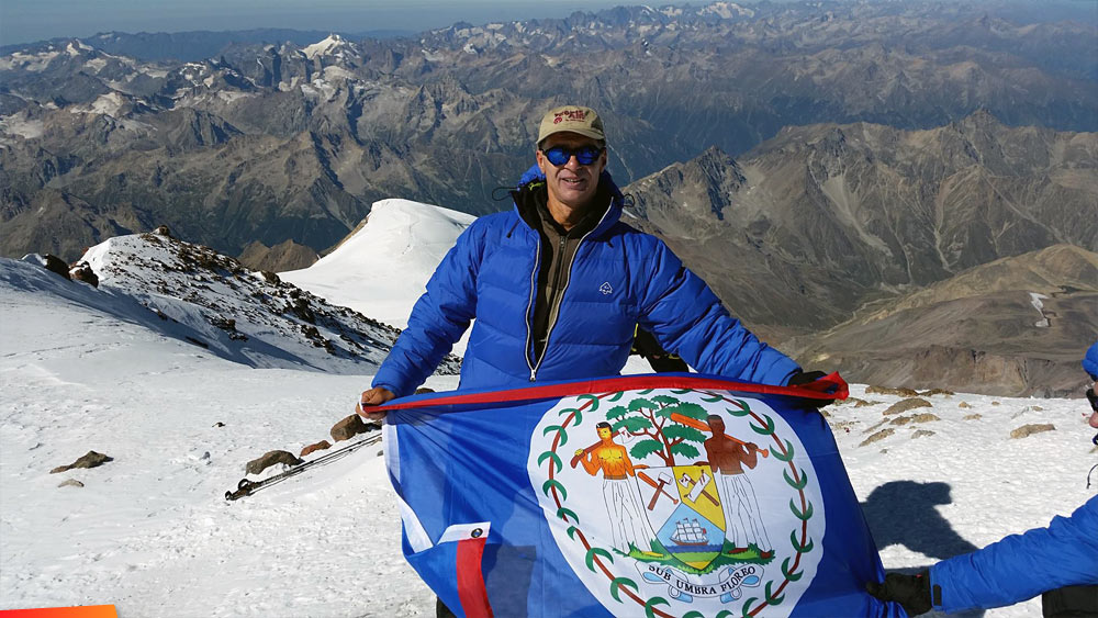 The Belizean flag is planted on Peak Elbrus, the highest European peak