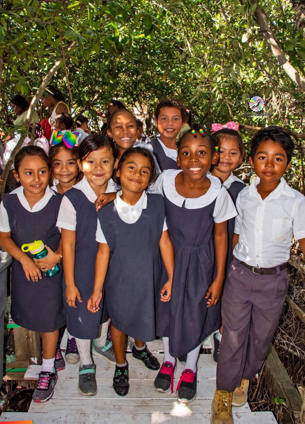 Group of children smiling in their school uniforms in San Pedro
