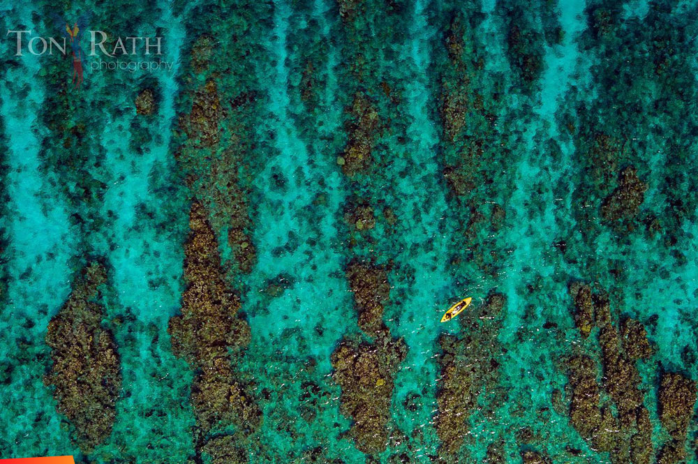 Aerial view: kayaking atop the spur and groove (coral formation alternating coral mounds with sand troughs) off South Water Caye