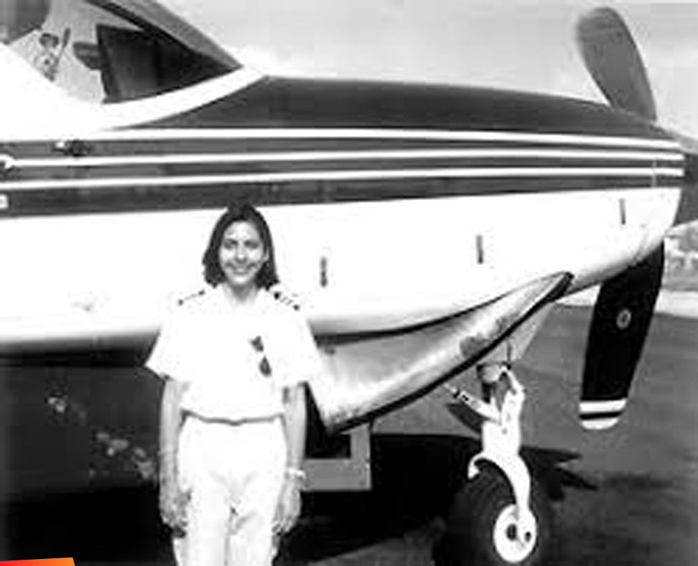 Florita Ancona, the first female Belizean pilot, in front of a plane in 1998
