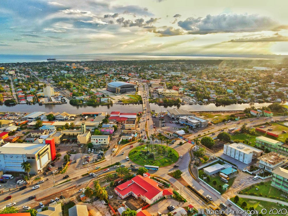 Aerial view of the Belize City roundabout looking toward Belcan Bridge and Central American Boulevard at Sunset