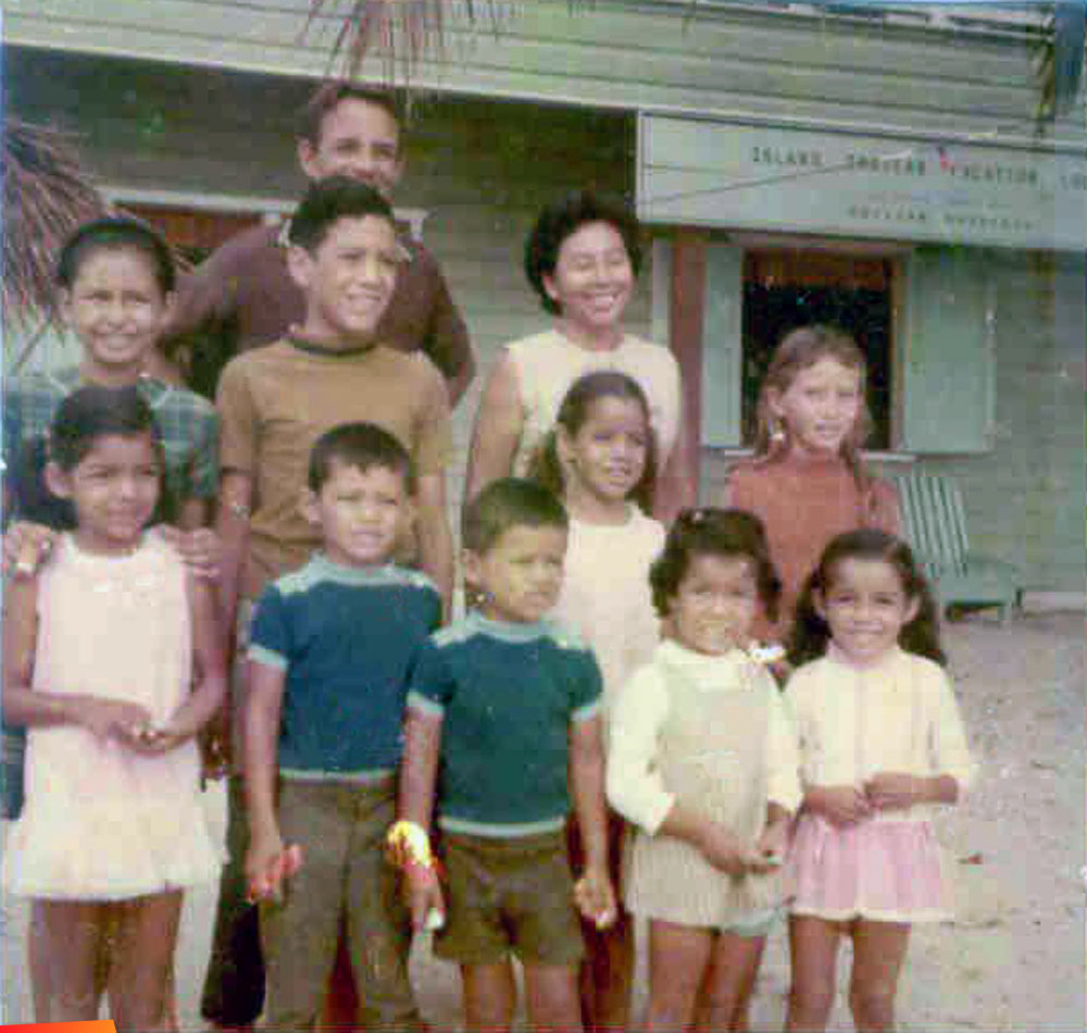 Early 1970s photo of the Auxillou family in front of the first hotel on Caye Caulker, the Hideaway Reef Lodge, owned by the Auxillou Family