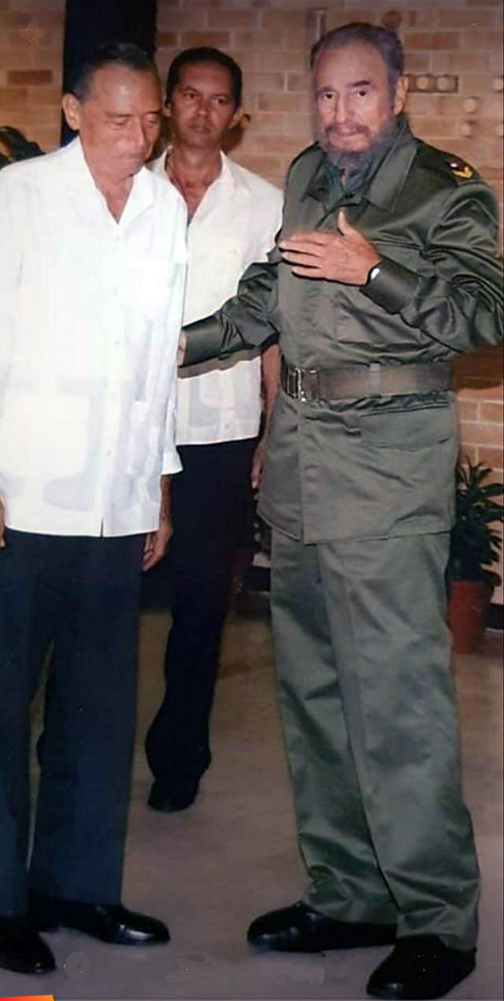 Hon. George Price having a conversation with Fidel Castro, 2005