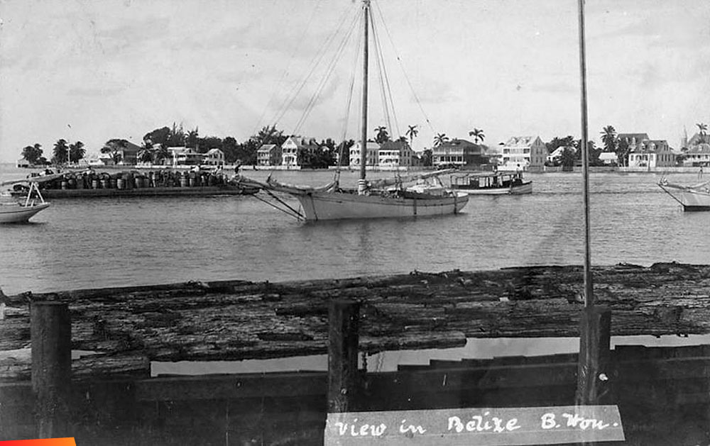 View of the river, boats, and buildings along the river, in Belize City, British Honduras, 1910s or 1920s