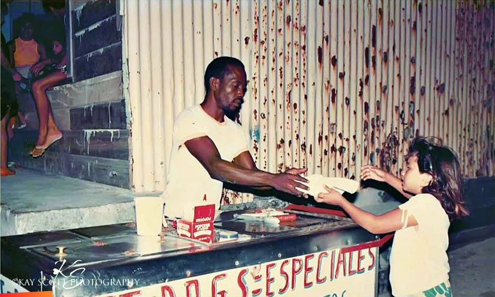 Melly Sanchez buying a hot dog from Sydney's hot dog cart at the now Jaguar's Nightclub in San Pedro, long ago