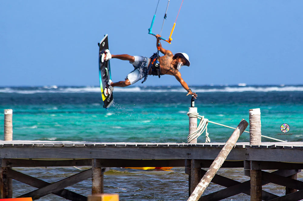 Anything for a Belikin. Kitesurfer snags a beer off the dock
