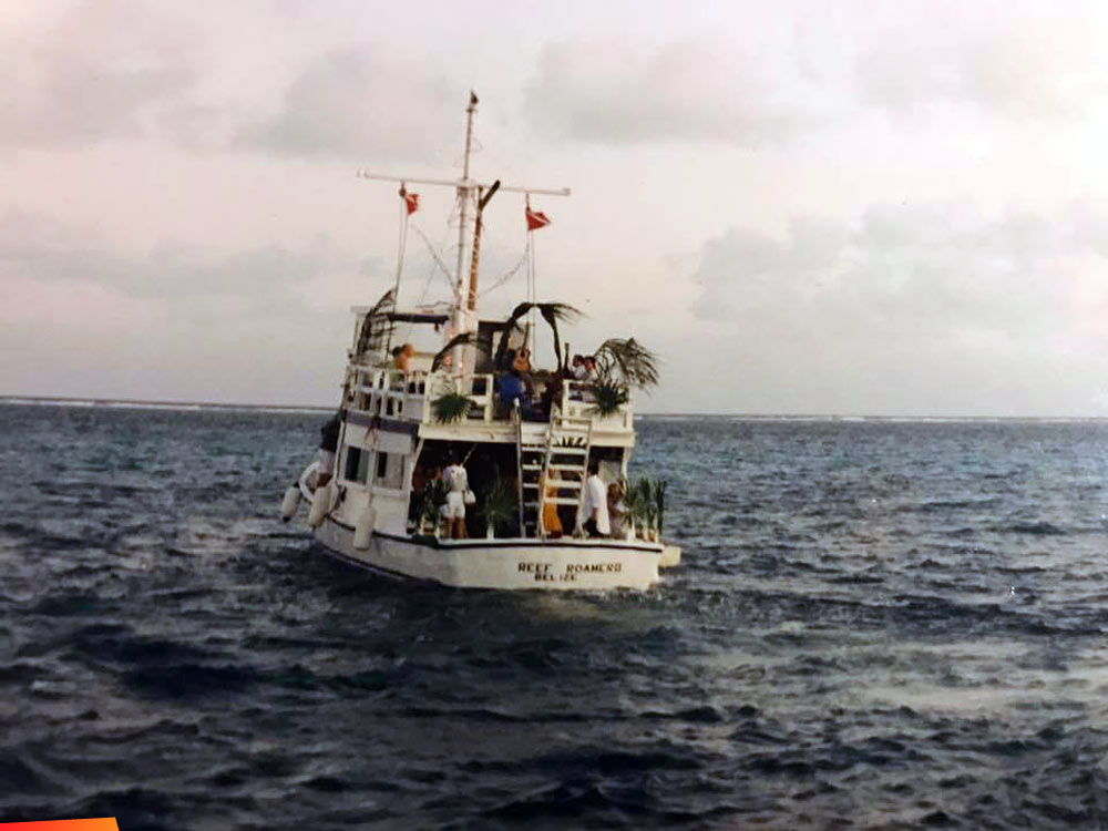 Reef Roamer II, Ray Bowers' boat with Out Island Divers heading out to reef for a cocktail party with palms decorated and musicians. Early 1990's San Pedro