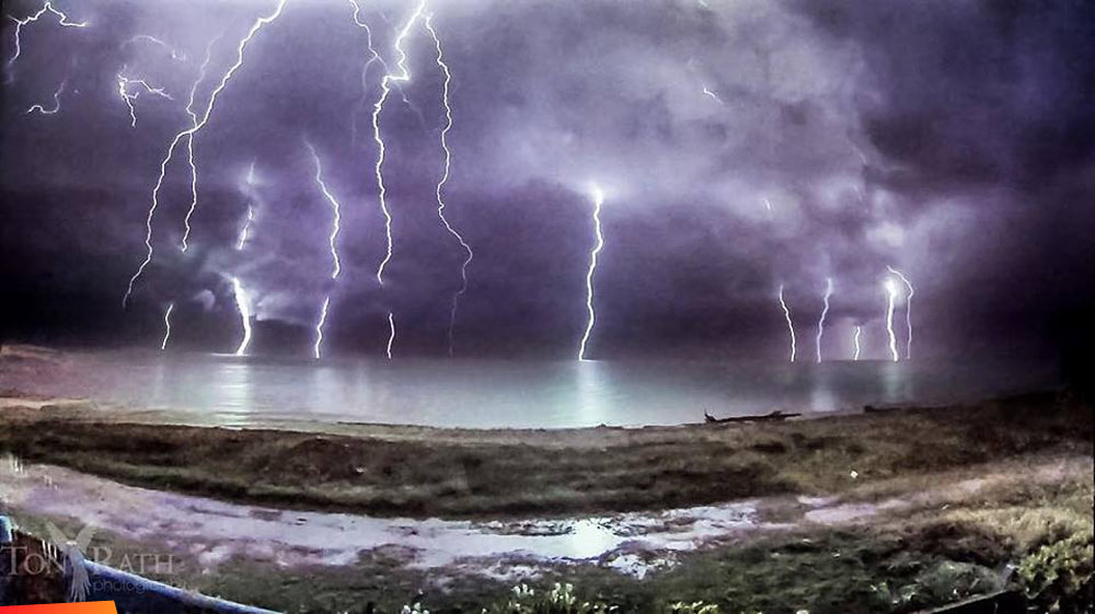 A wet time lapse of a lightning storm moving onshore from right to left