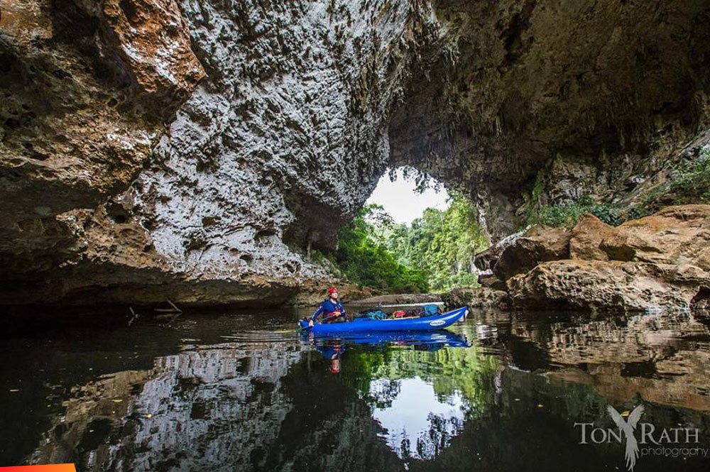 Kayaking the Chiquibul River as it flows under the Natural Arch