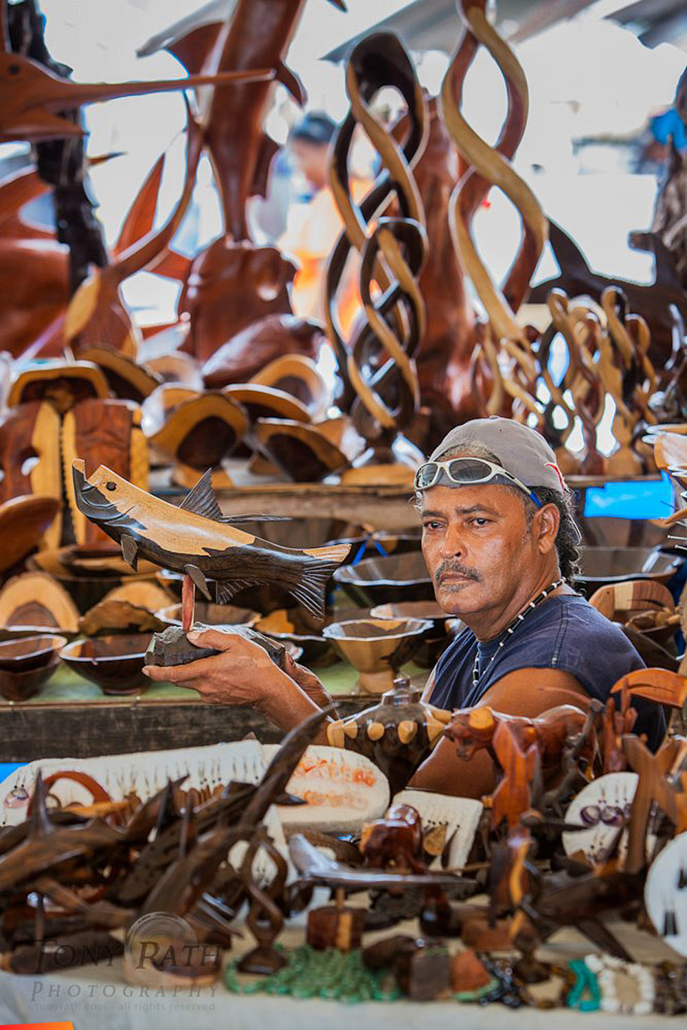 A Placencia sculptor, lots of wood carvings on display