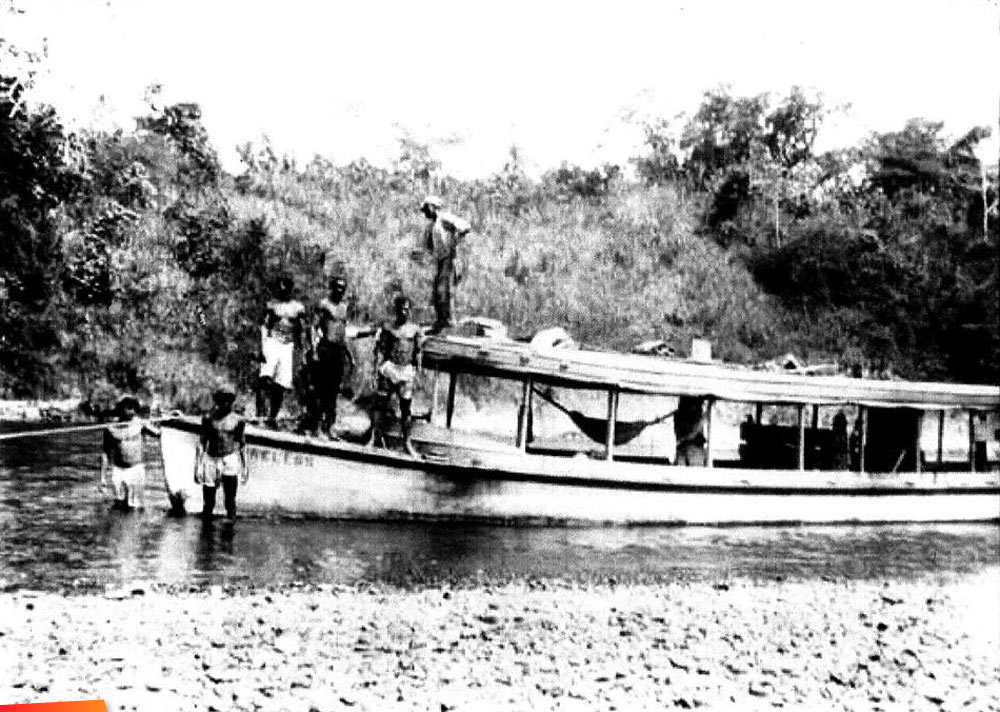 One of the large Belize City - Cayo river boats moving up a shallow, long ago