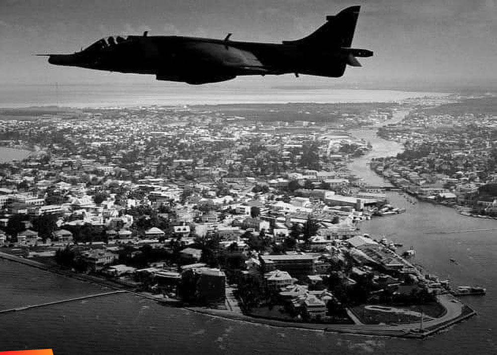 A British Aerospace Harrier II hovers above Belize City keeping the air space safe, 1980's