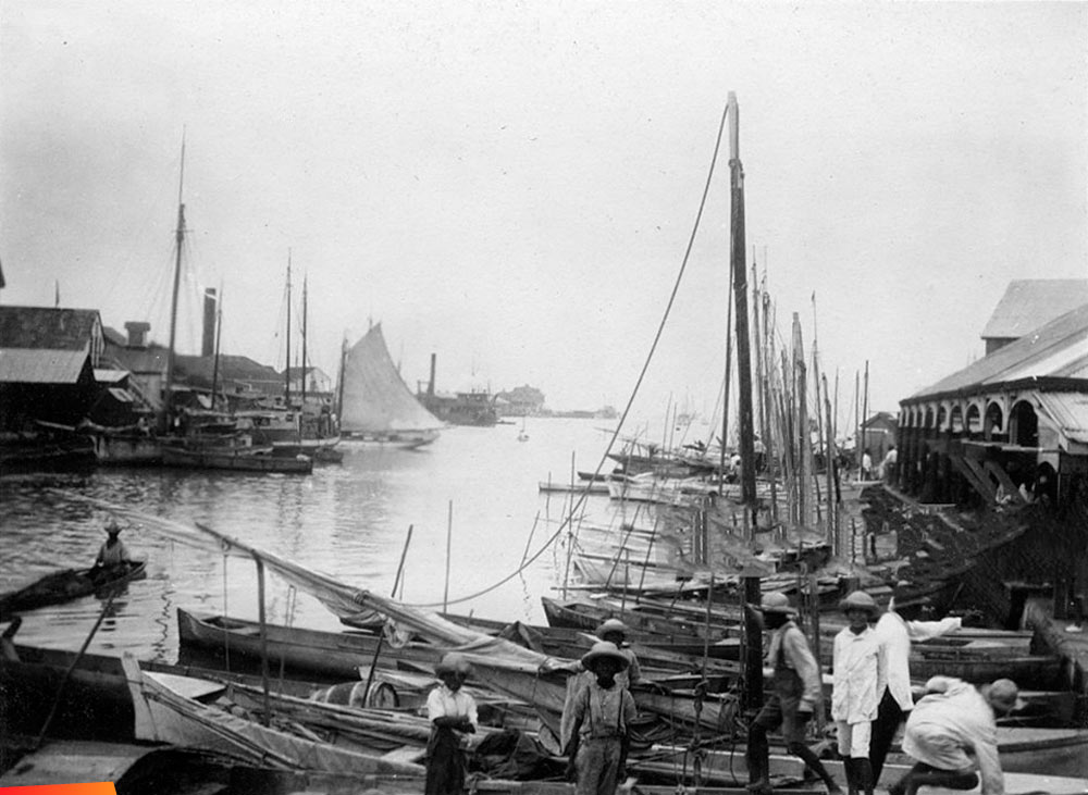 In front of the Belize City Market by the swing bridge along the river looking to the sea, 1923 and 1978