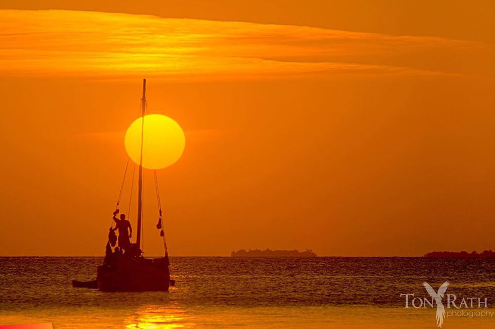 Sailboat watching the sunset at South Water Caye