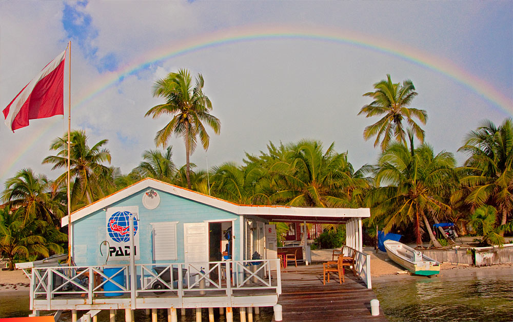 Rainbow to the west at sunrise, White Sands Dive Shop on northern Ambergris Caye
