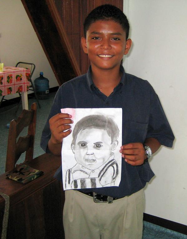 Nelcito Juarez with a drawing of himself as a baby