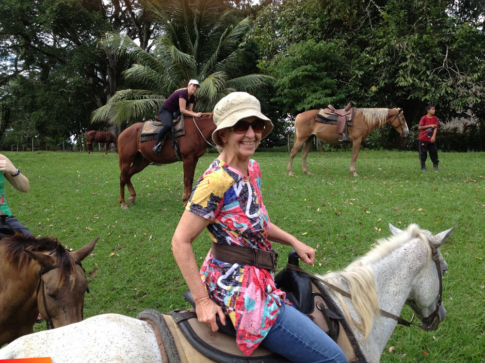 Susan and Wil Lala take a horseback ride at Banana Bank with John Carr and Sherman