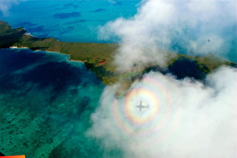 Rainbow reflections flying from Ambergris Caye to Belize City, plane silhouette inside rainbow