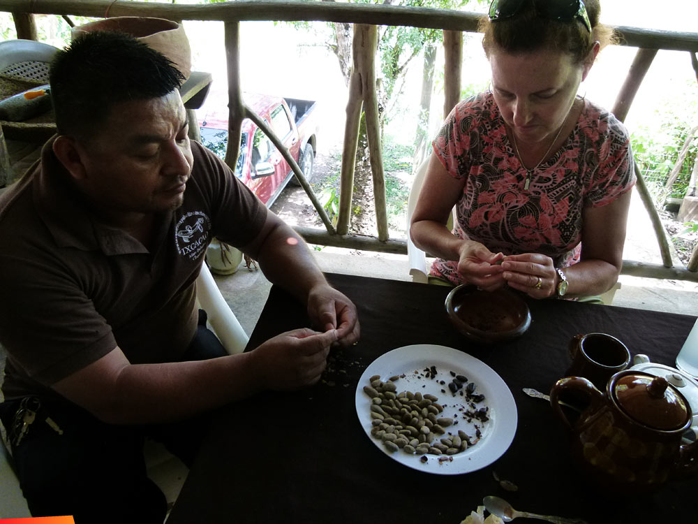 Making chocolate at IXCACAO Maya Belizean Chocolate, grinding the beans by hand. San Felipe