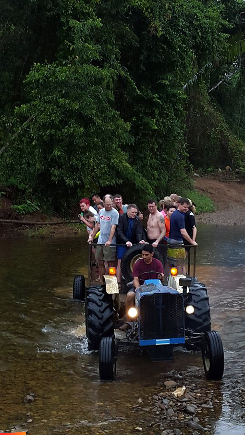 Big cave tubing group crossing the river in a tractor