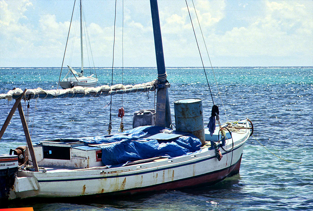 A lobster boat anchored in front of town, 1980's