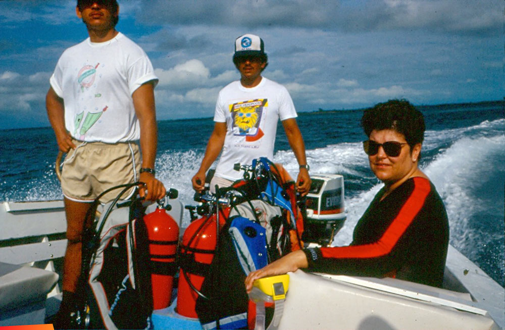 Eddie Alamilla, Changa Paz, and Sheri Luepke in a boat, January 1990